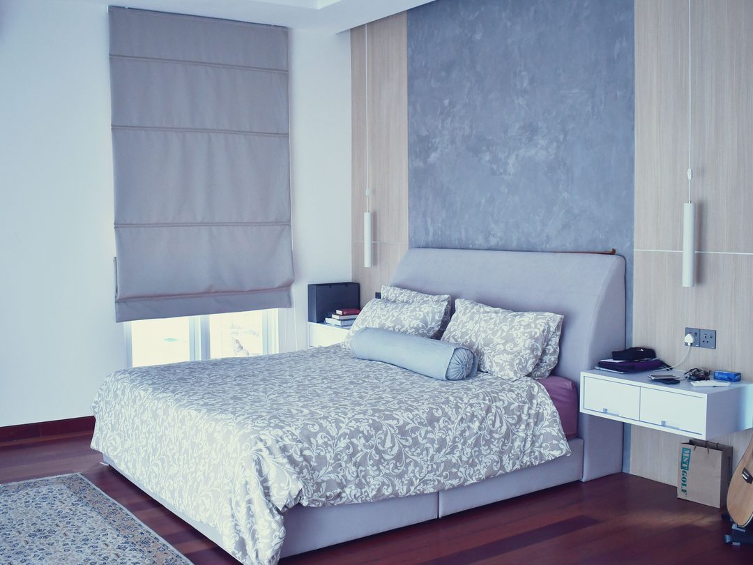 Bedroom with grey feature wall and roman blinds