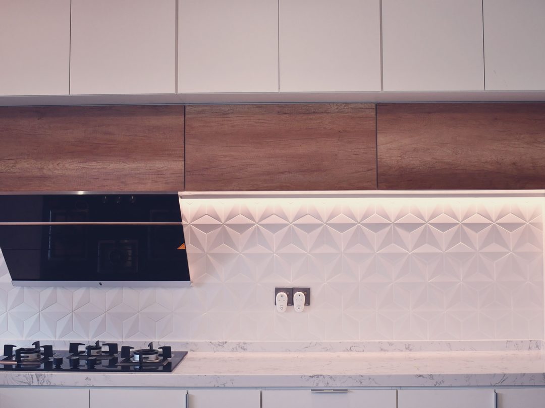 Kitchen with geometric tile splashback and timber accents