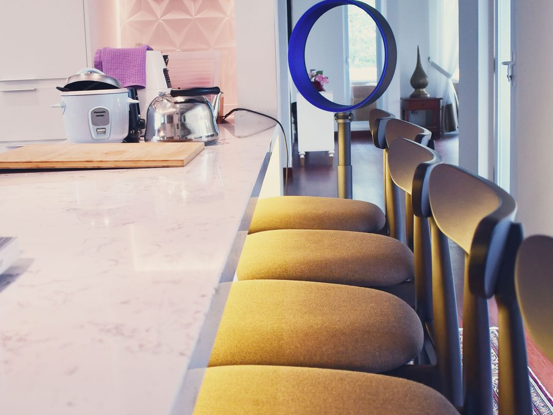 Marble breakfast bar with mustard bar stools
