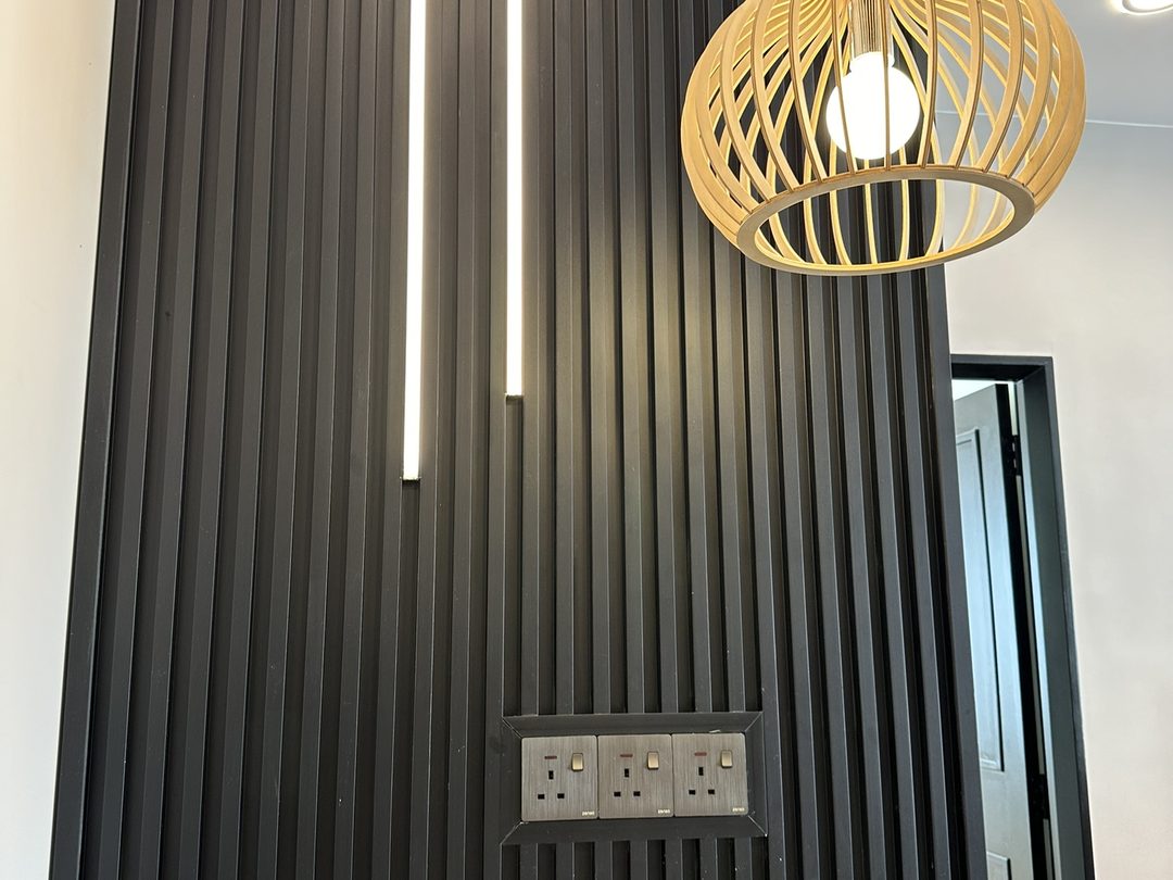 Black slat feature wall with rattan pendant