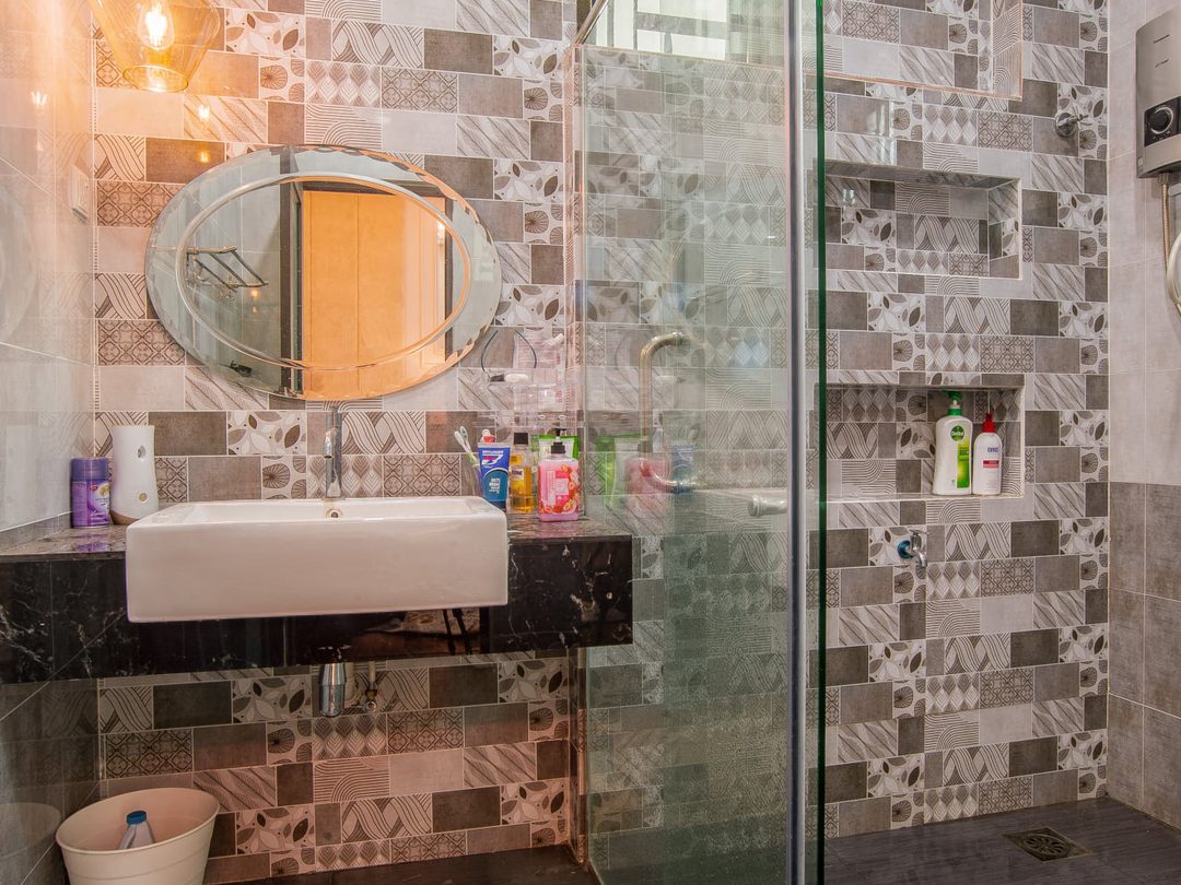 Bathroom with patterned feature tiles and glass shower