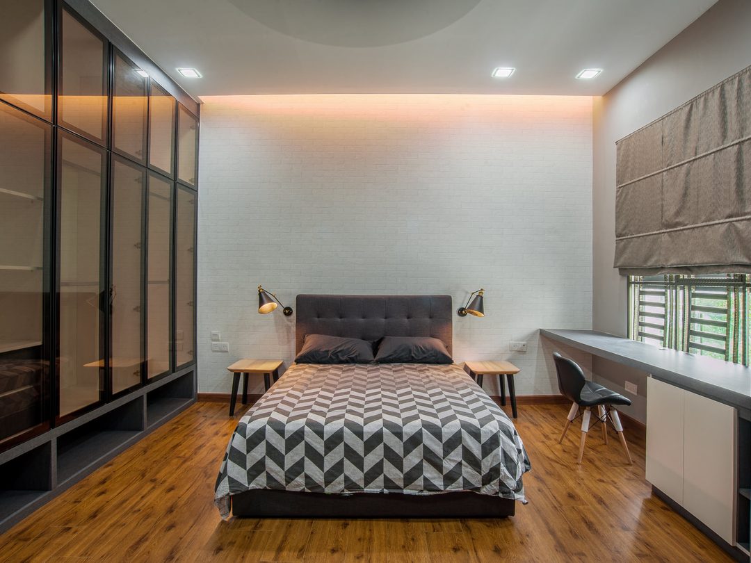 Master bedroom with upholstered headboard wall and study nook