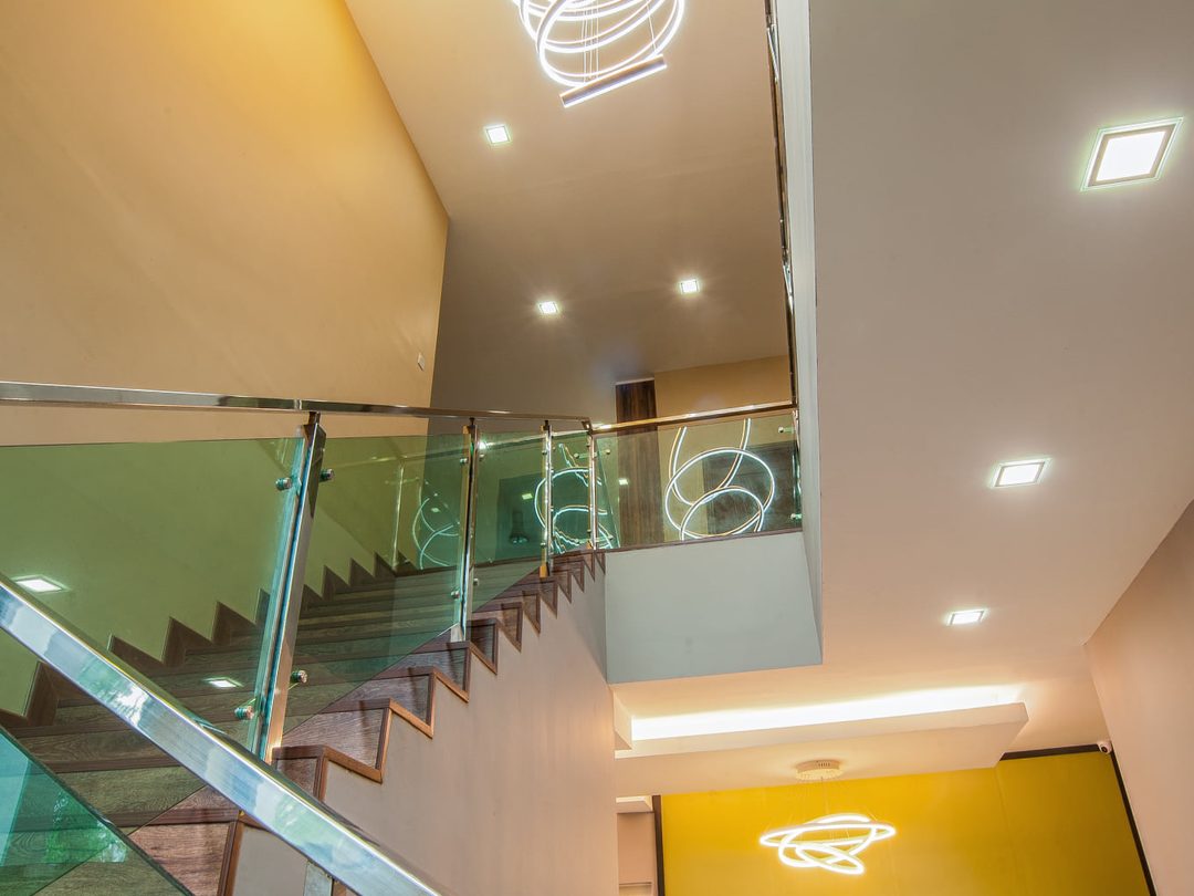 Staircase with ring pendant lights over a double-height void