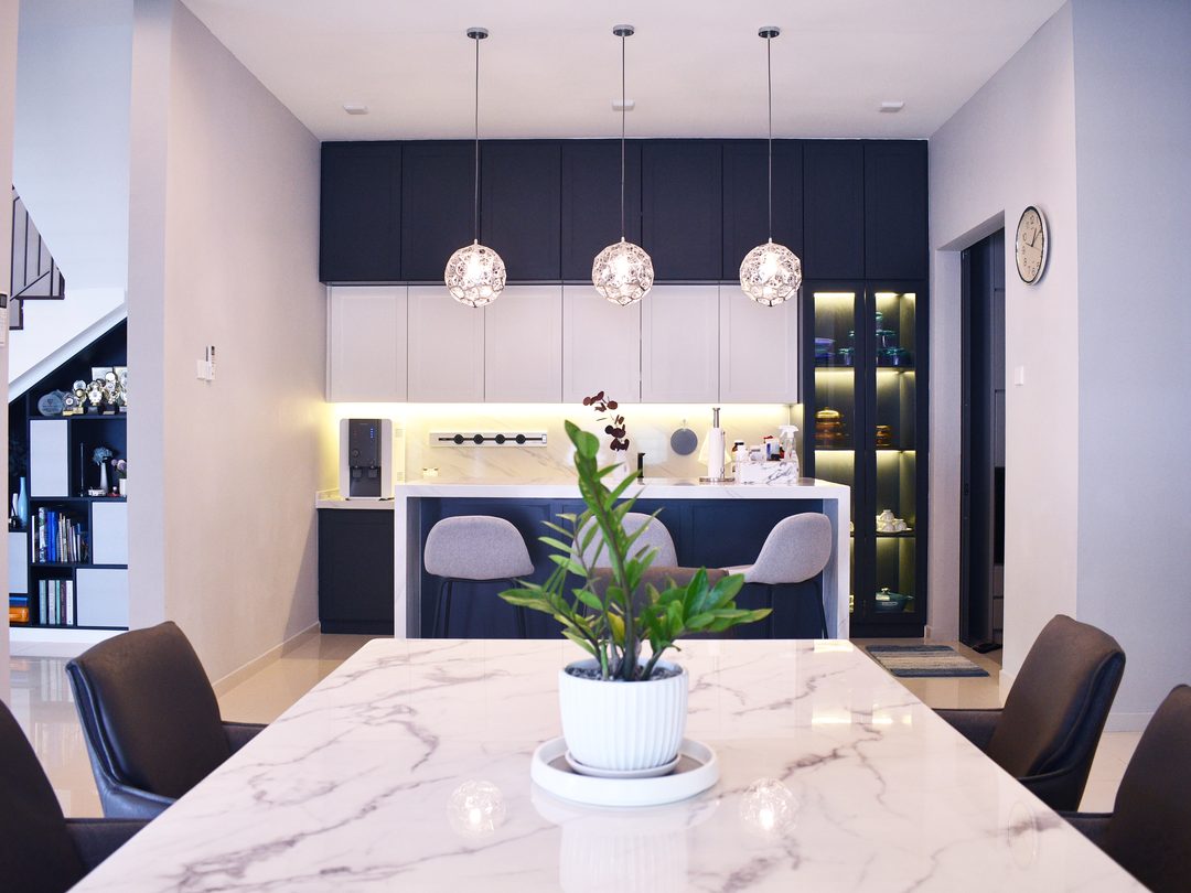 Kitchen island in veined quartz with navy cabinetry, Saujana Impian