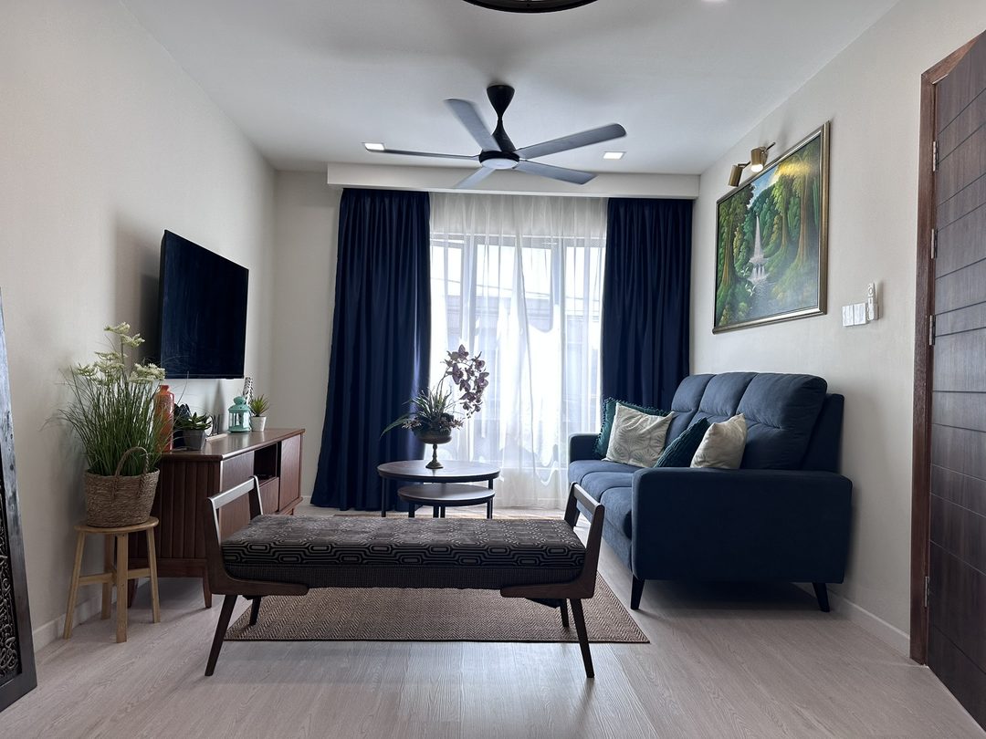 Living room with a navy sofa, upholstered bench and wall-mounted TV