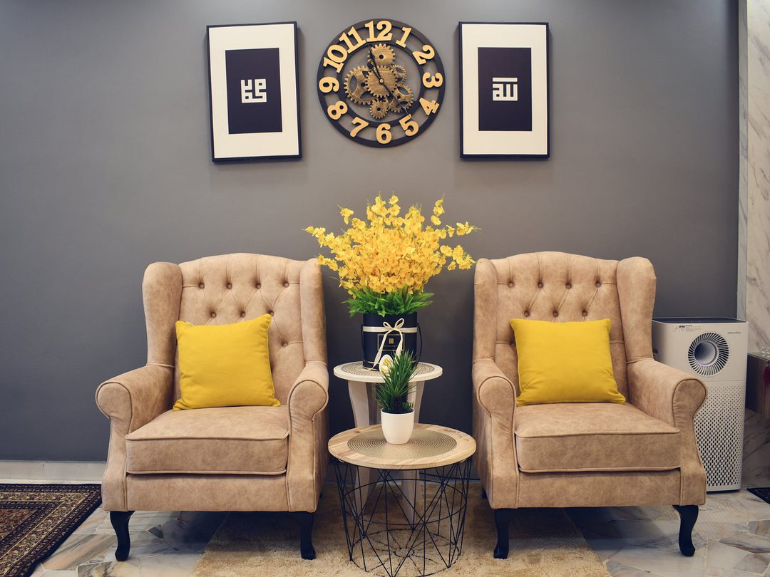 Wing chairs under a wall clock gallery