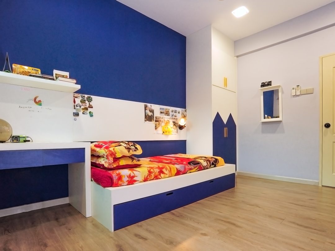 Kids bedroom with house-shaped headboard in royal blue