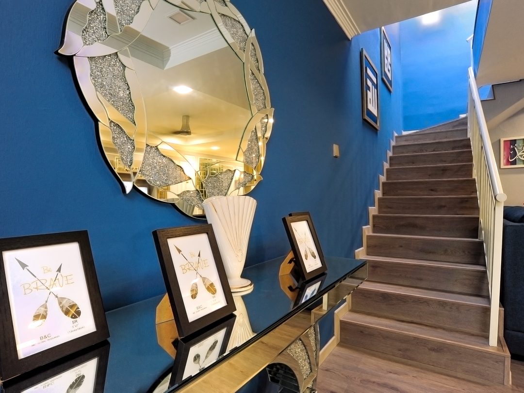 Staircase gallery in deep blue with framed art