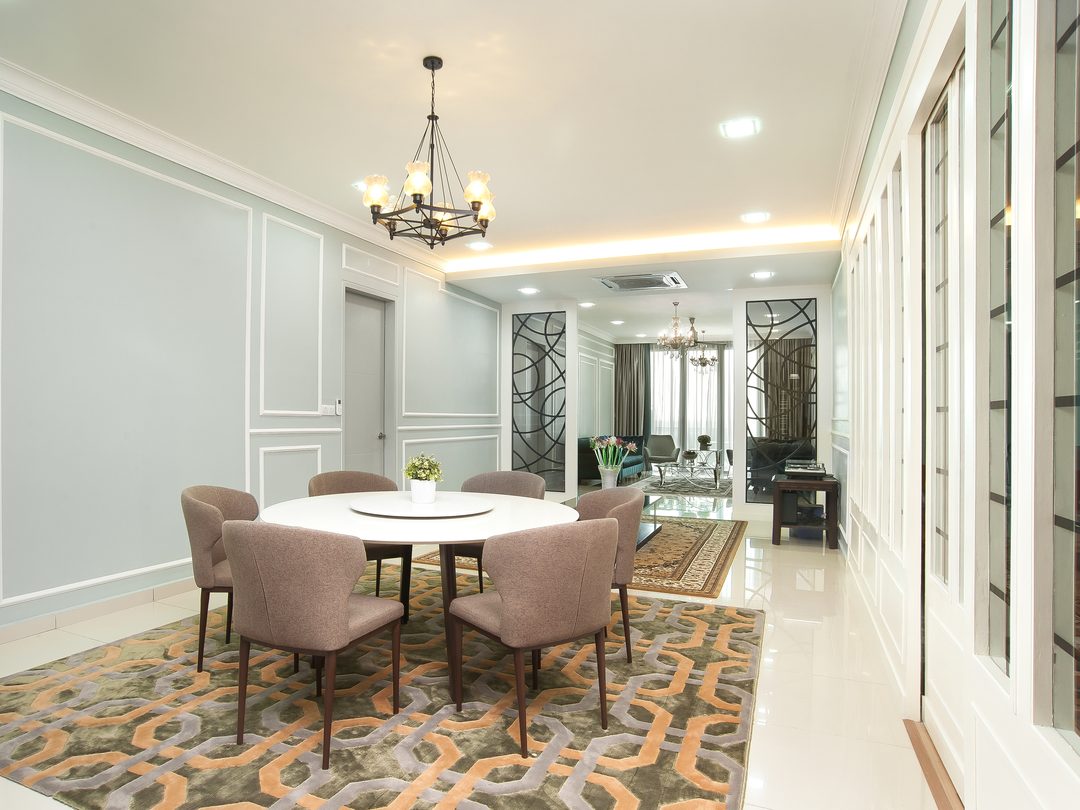 Dining room with round marble table and patterned carpet