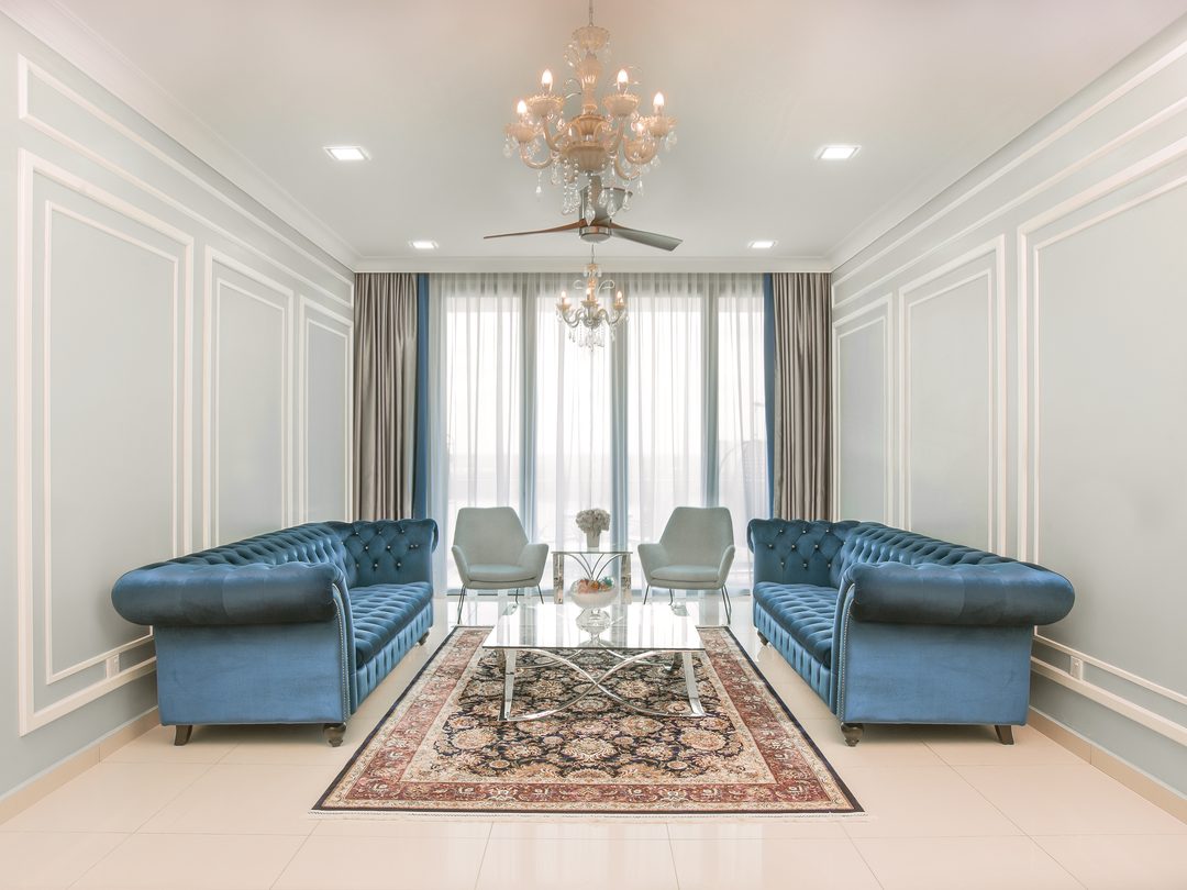 Living room with teal chesterfield sofas