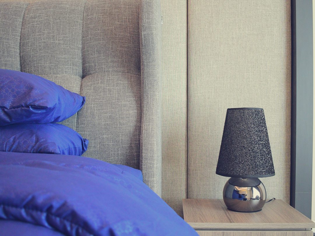 Bedroom with padded headboard wall