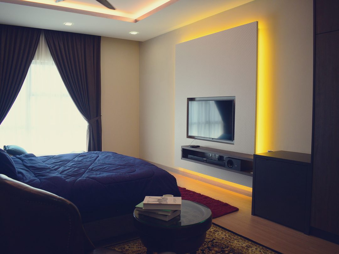 Bedroom media wall with cove lighting
